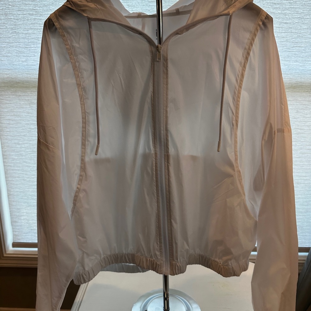 Ideology lightweight jacket, white, hits at the waist.